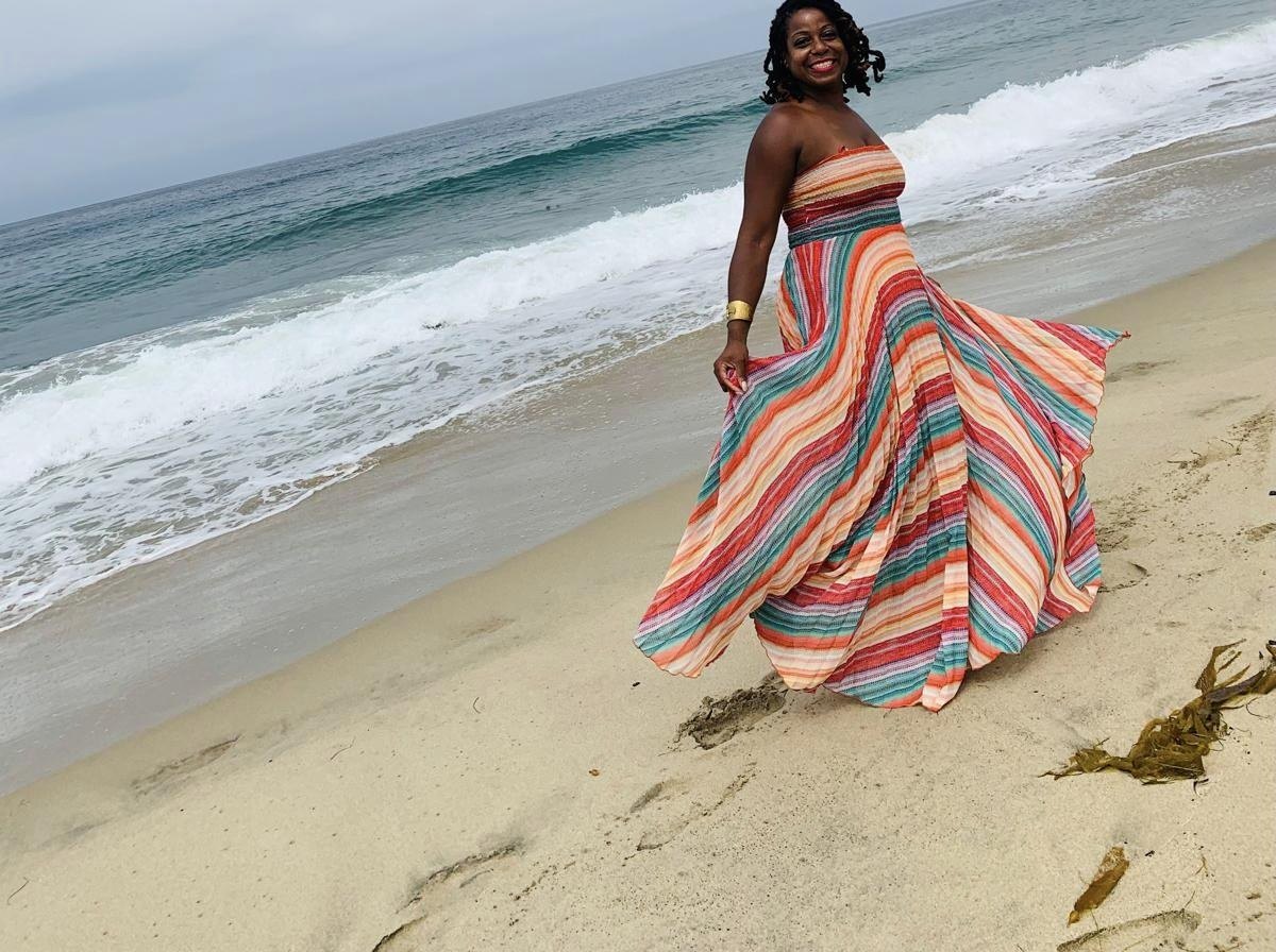 Terry on the beach in a flowing striped dress