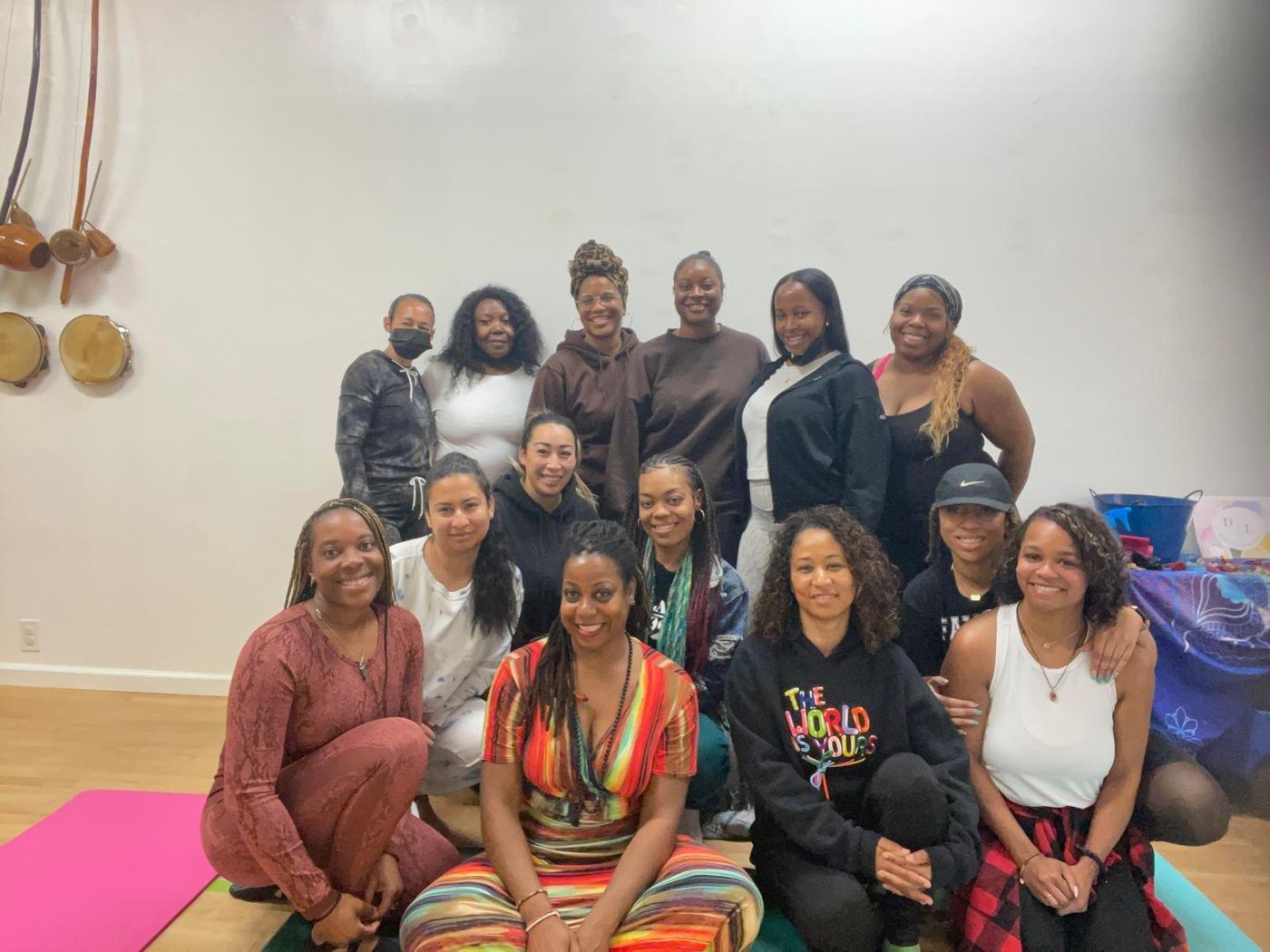 A women's circle smiling together