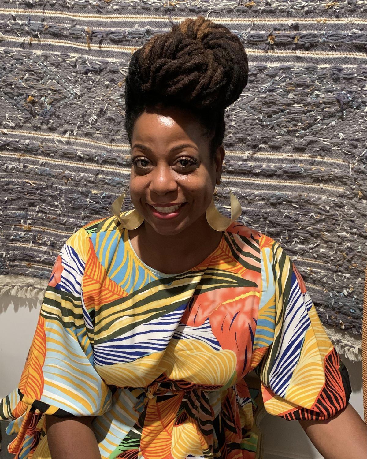 Terry smiling in a bright tropical print top